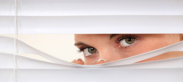 Woman peering through blinds © auremar - Fotolia.com #45534695